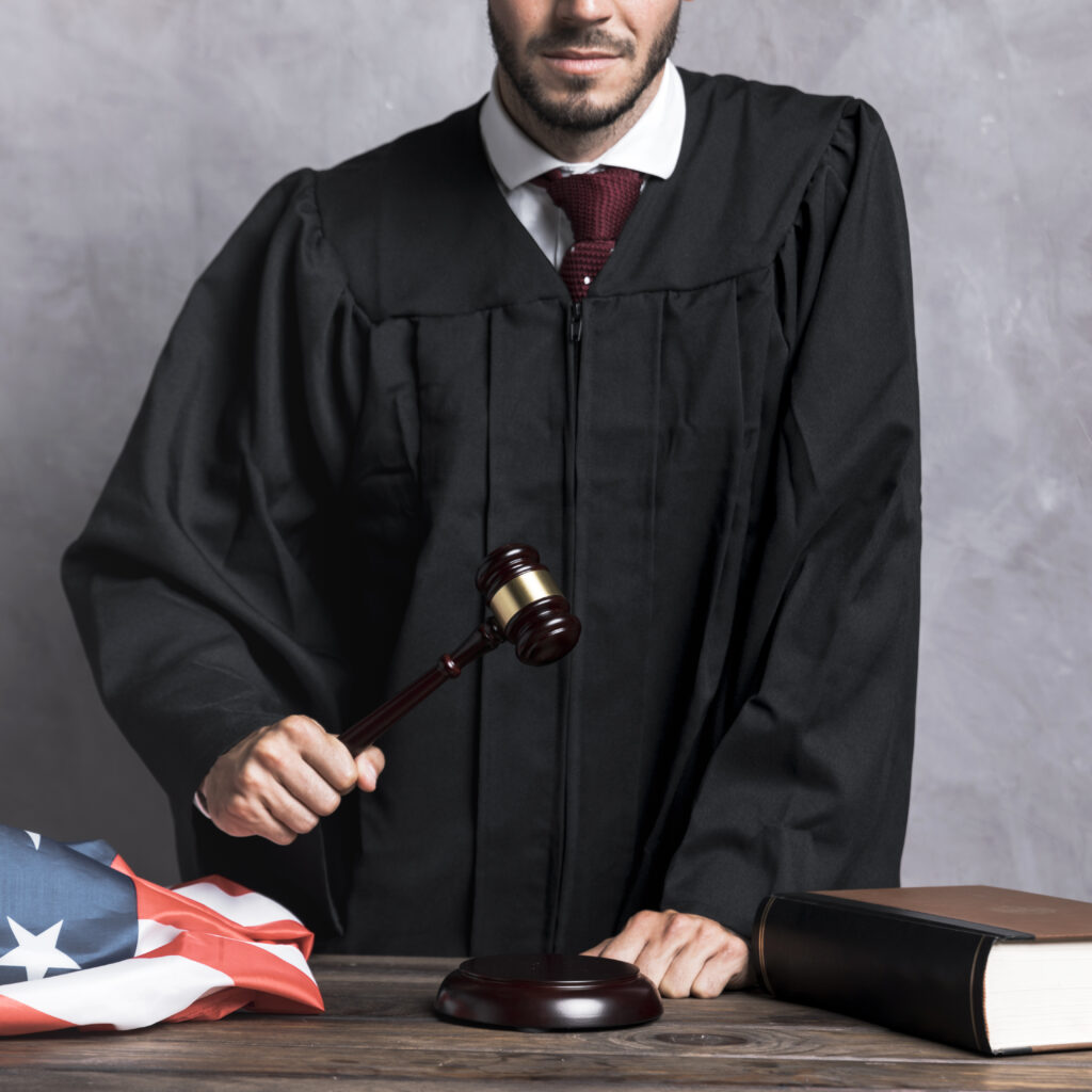 close up judge with gavel stucco background